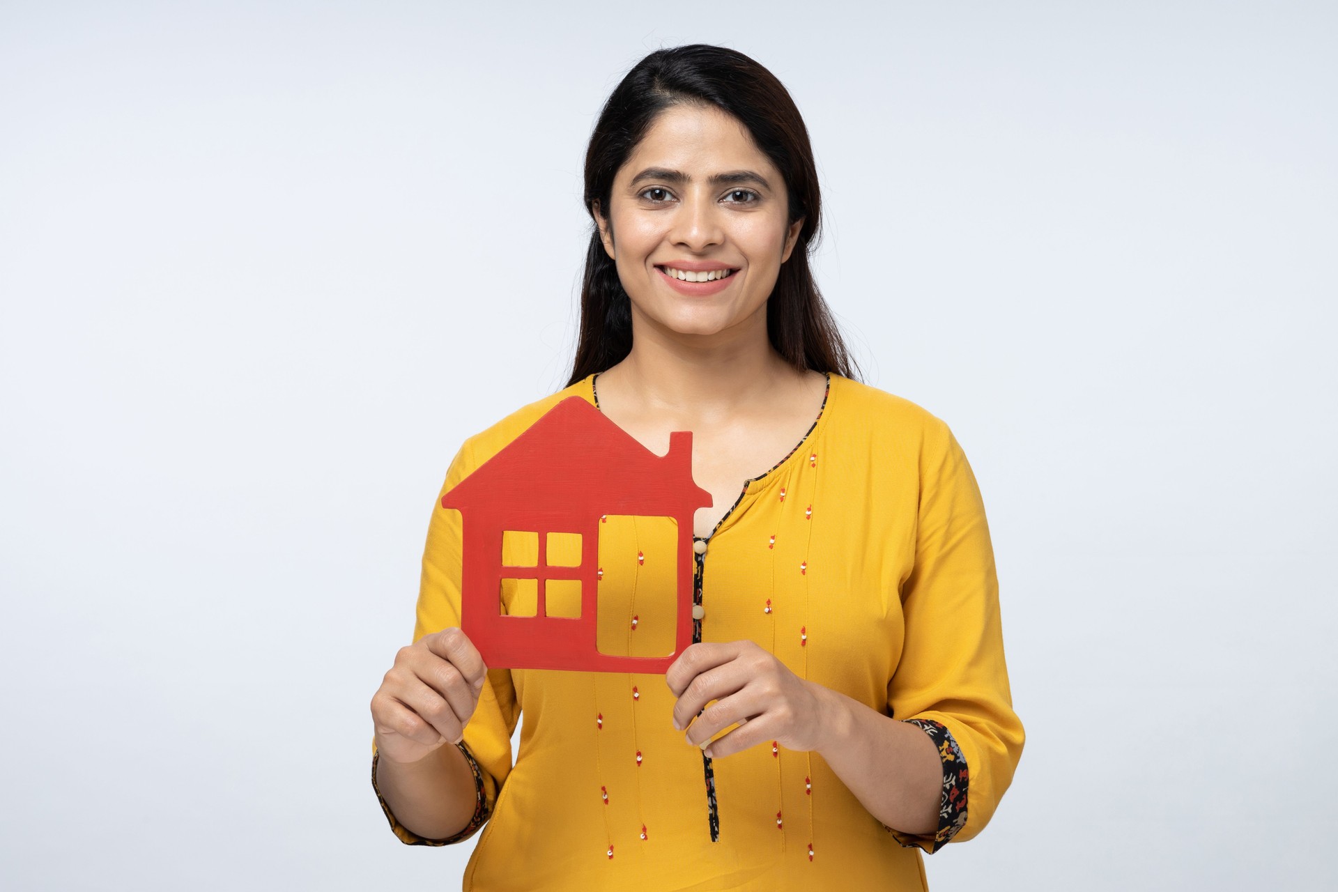 Photo of young positive woman moving hold small house isolated on white background stock photo